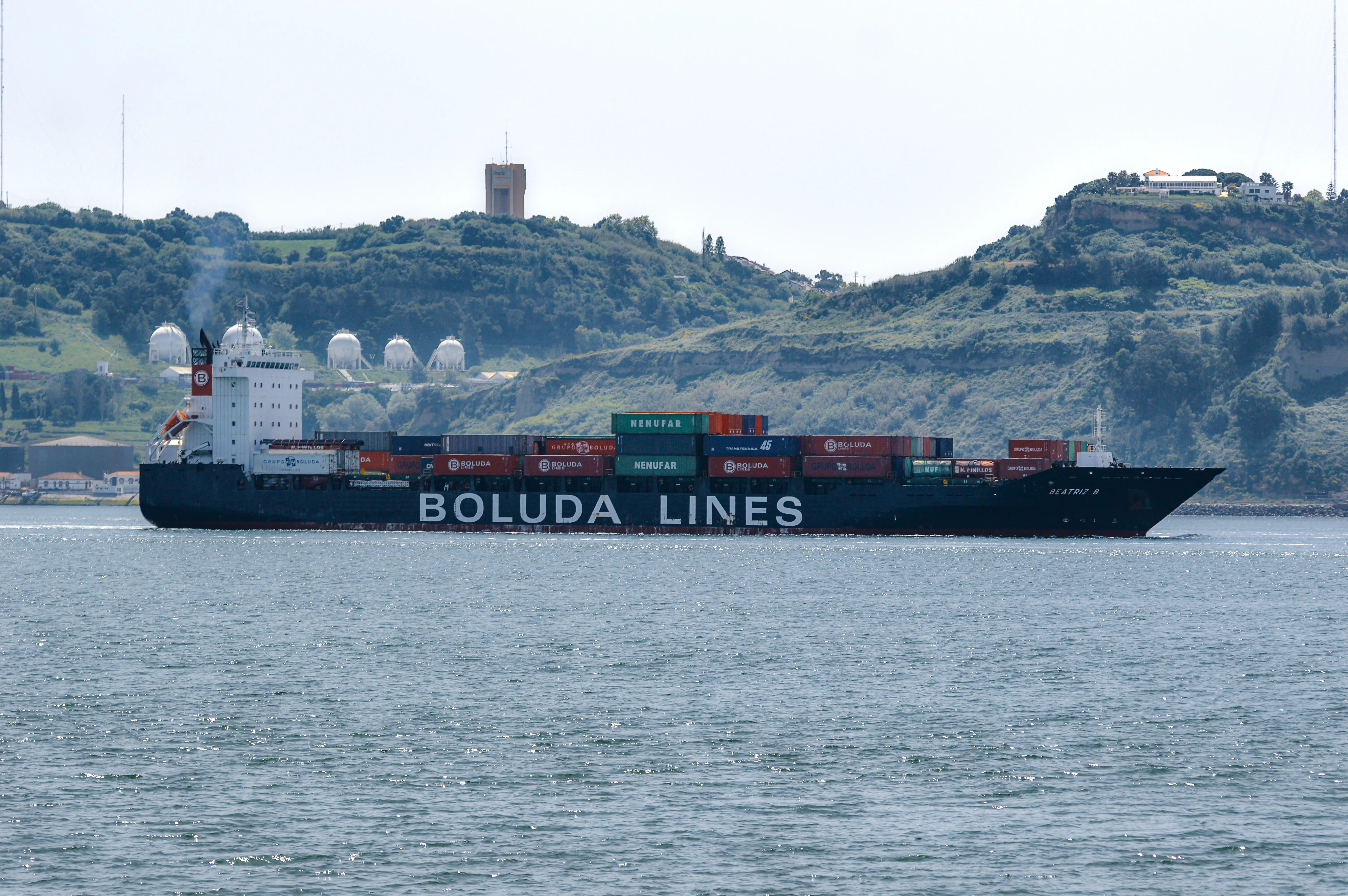 A black and dark grey container ship named 'Beatriz B' with 
